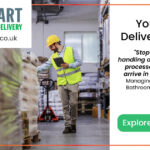 man in a warehouse wearing a yellow hard hat and a high-vis jacket, taking notes of some packages